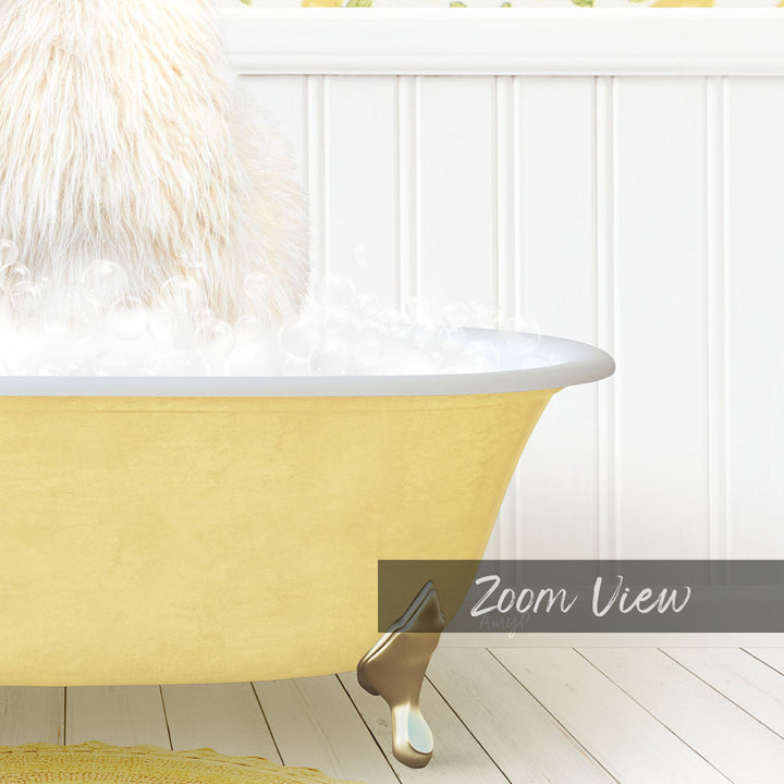 A fluffy white dog is sitting in a yellow bathtub filled with bubbles, with a white wall and wooden floor in the background.