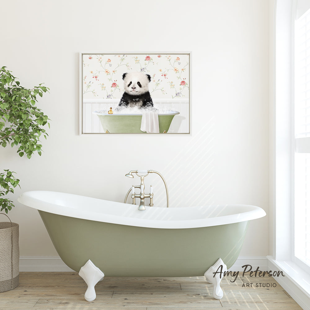A framed image of a panda sitting in a bathtub is displayed on the wall above a green clawfoot bathtub in a bathroom.