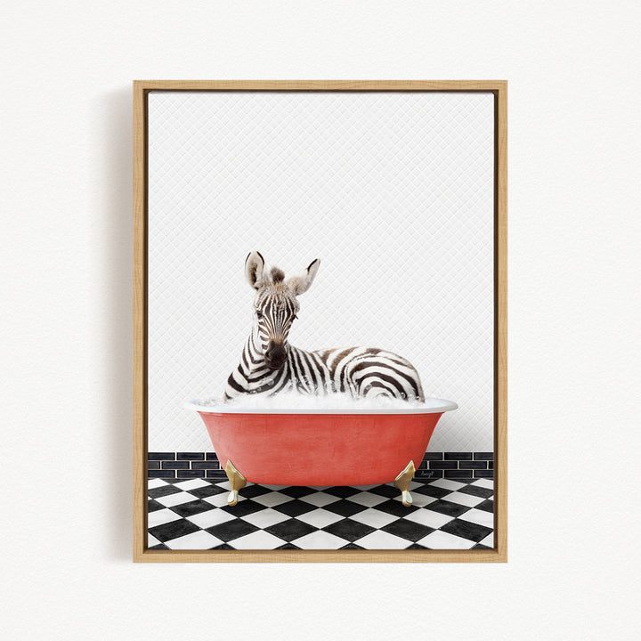 A zebra is sitting in a red bathtub on a black and white checkered floor.