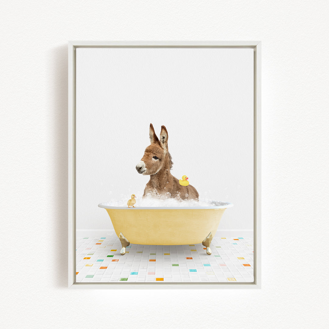 A donkey is sitting in a yellow bathtub filled with bubbles, surrounded by rubber ducks.