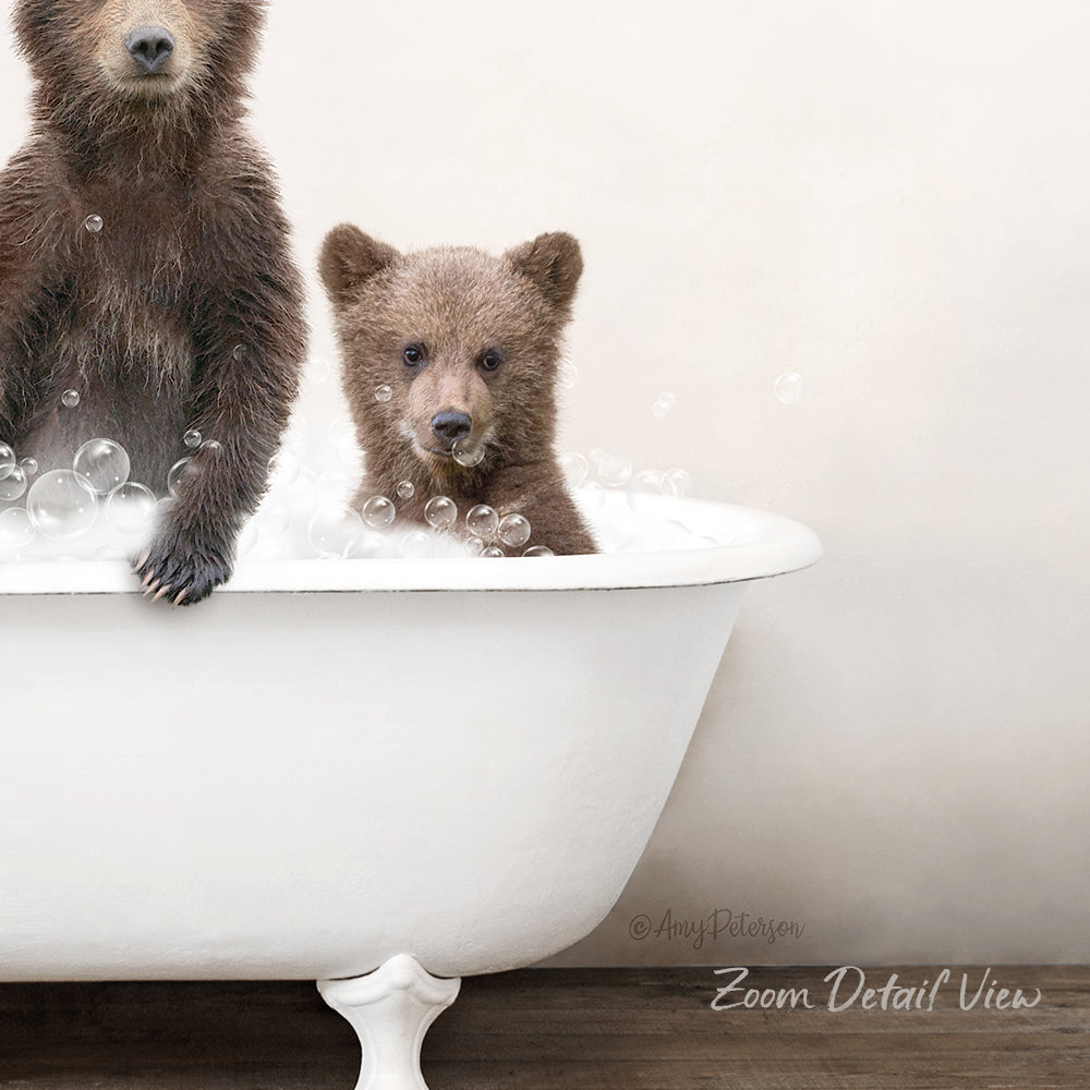 Two brown bears enjoying a bath together in a white bathtub.