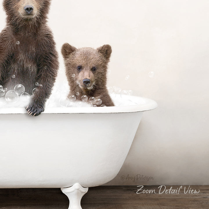 Two brown bears enjoying a bath together in a white bathtub.