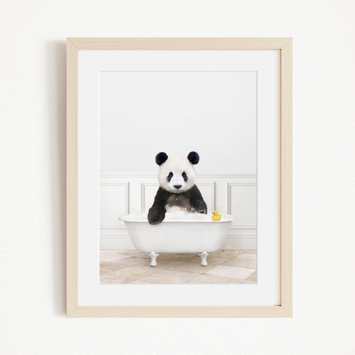 A panda bear sitting in a white bathtub, surrounded by a yellow rubber duck.