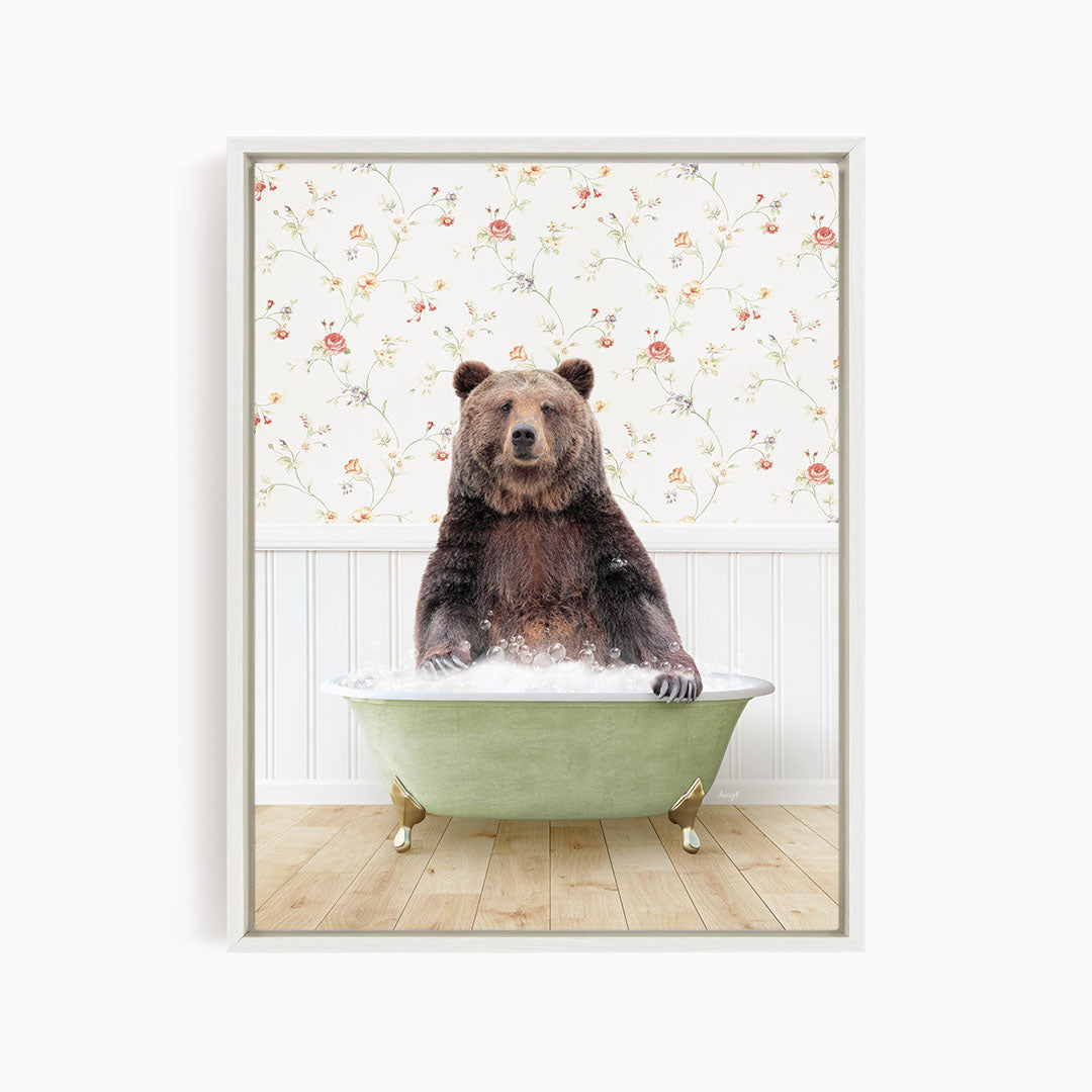A brown bear sitting in a green bathtub filled with water, with a floral wallpaper in the background.