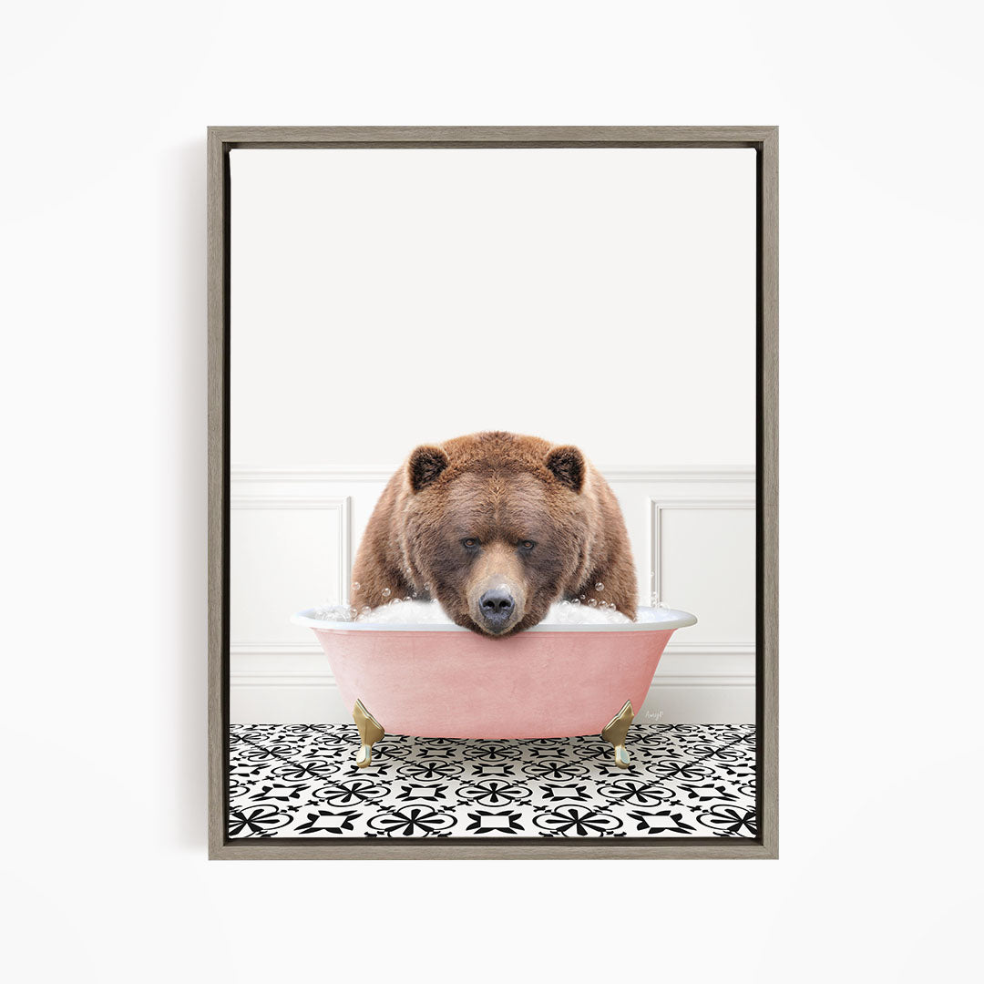 A brown bear is sitting in a pink bathtub filled with water, appearing to be enjoying a bath.