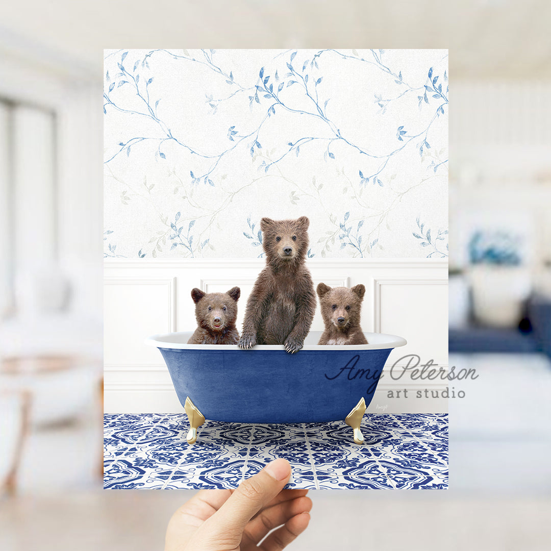 a person holding a card with three bears in a bathtub