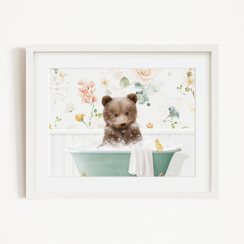 A cute brown bear cub sitting in a green bathtub filled with bubbles, surrounded by a floral background.