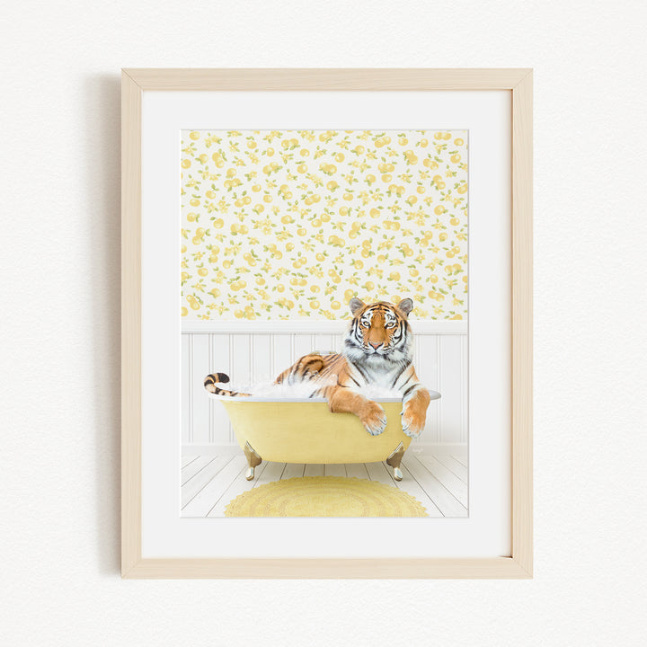 A tiger is sitting in a yellow bathtub, surrounded by a yellow and white floral pattern on the wall behind it.