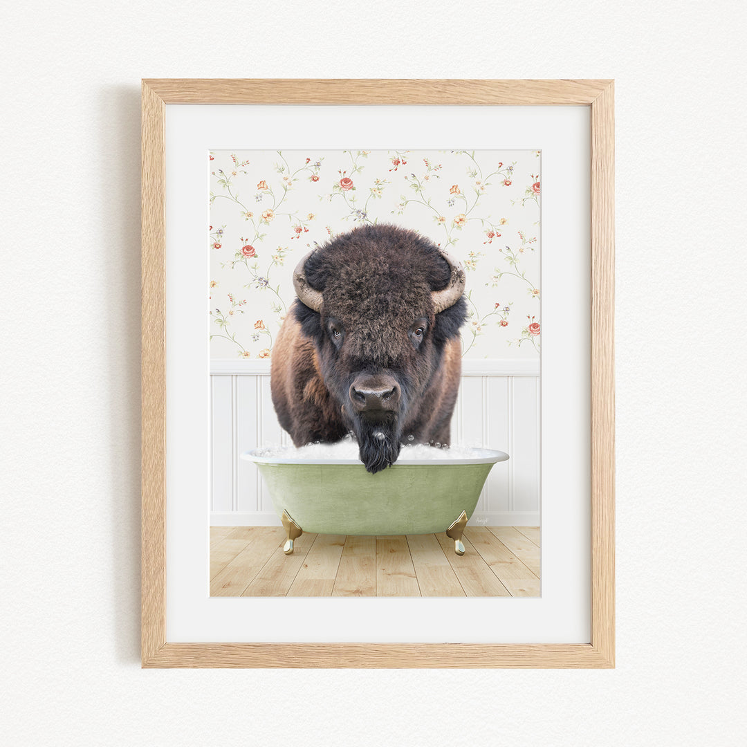 A buffalo standing in a green bathtub, with a floral patterned wall behind it.