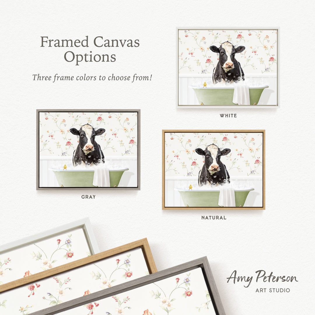 The image is a framed canvas with three different options for the color of the frame: white, gray, and natural. The canvas features a black and white cow sitting in a green bathtub, and the three frame options are displayed below the image.