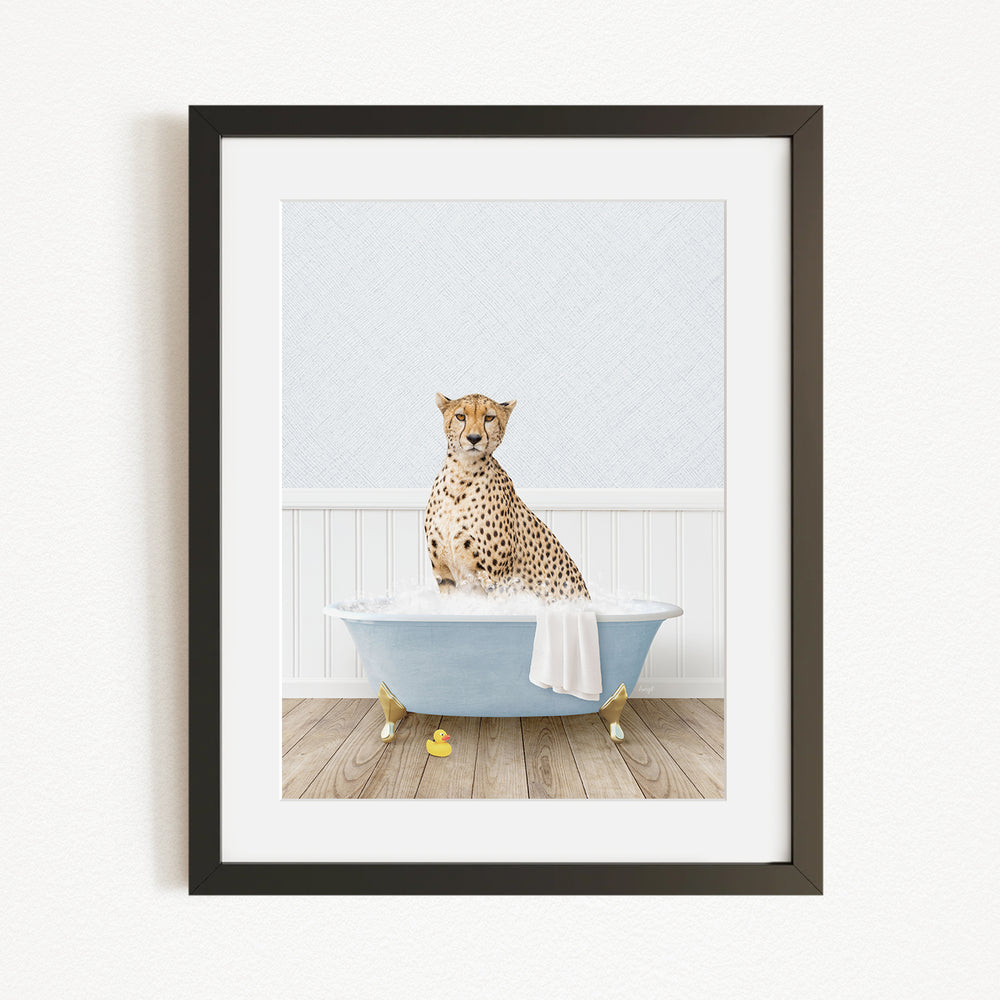 A cheetah sitting in a blue bathtub filled with water, surrounded by rubber duckies.