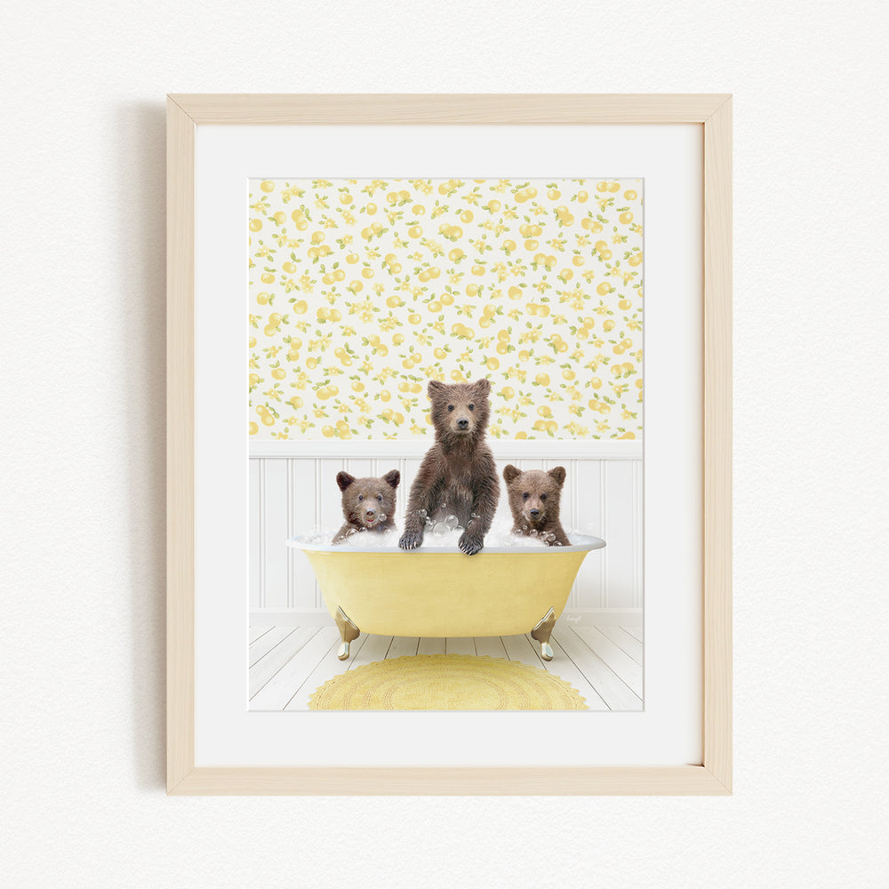 Three adorable brown bears sitting in a yellow bathtub, with a yellow floral wallpaper in the background.
