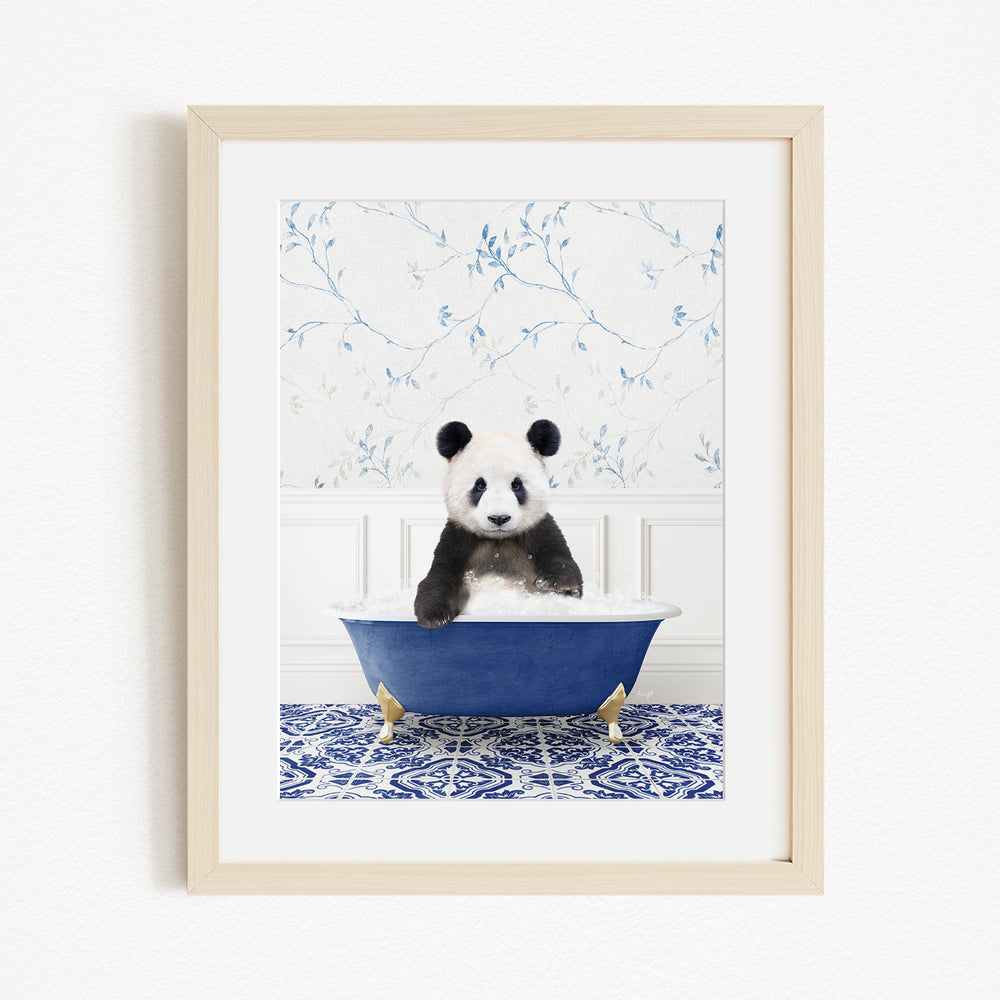 A panda bear sitting in a blue bathtub, surrounded by a blue and white floral patterned wall.