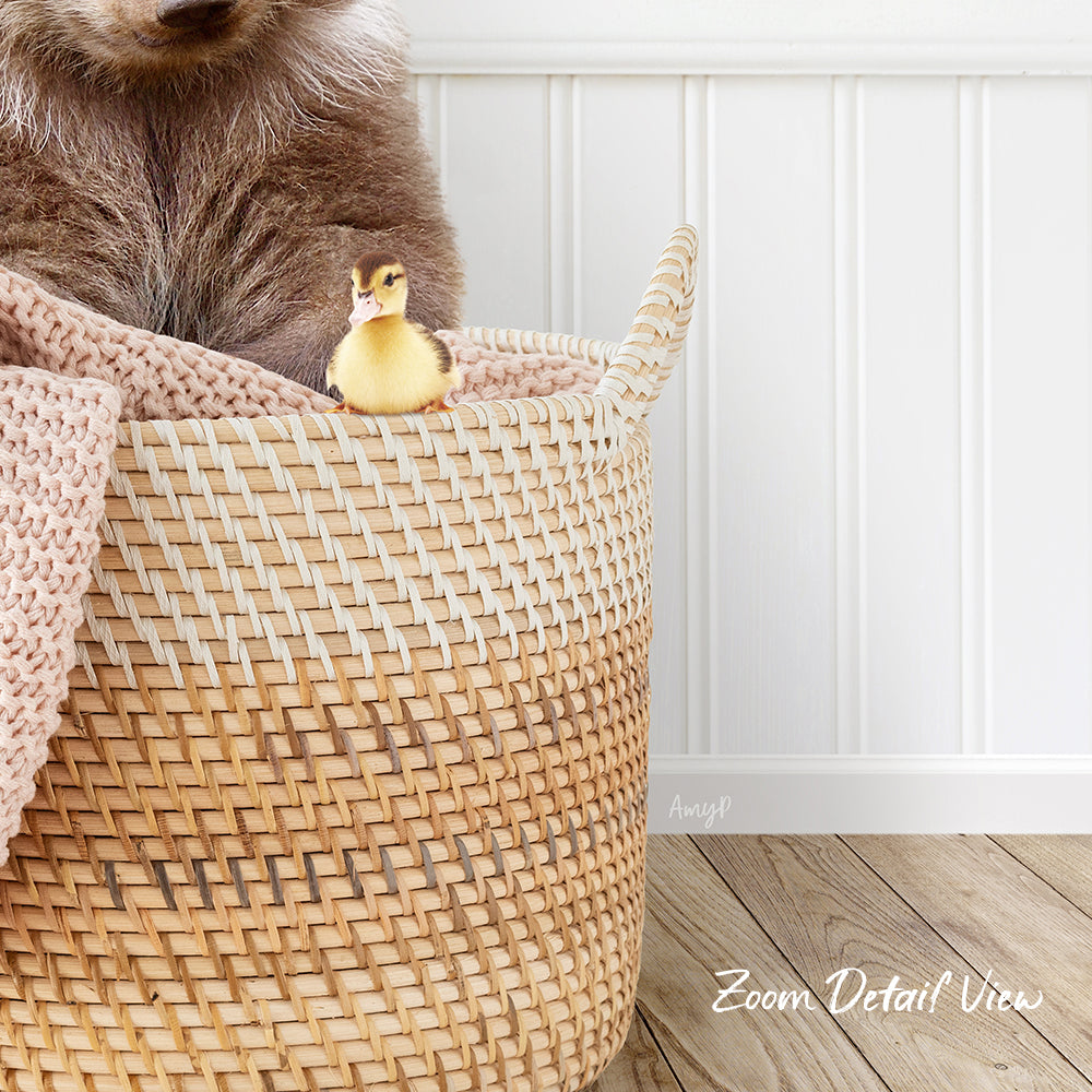 A small yellow duck sits in a woven basket, with a brown bear sitting next to it.