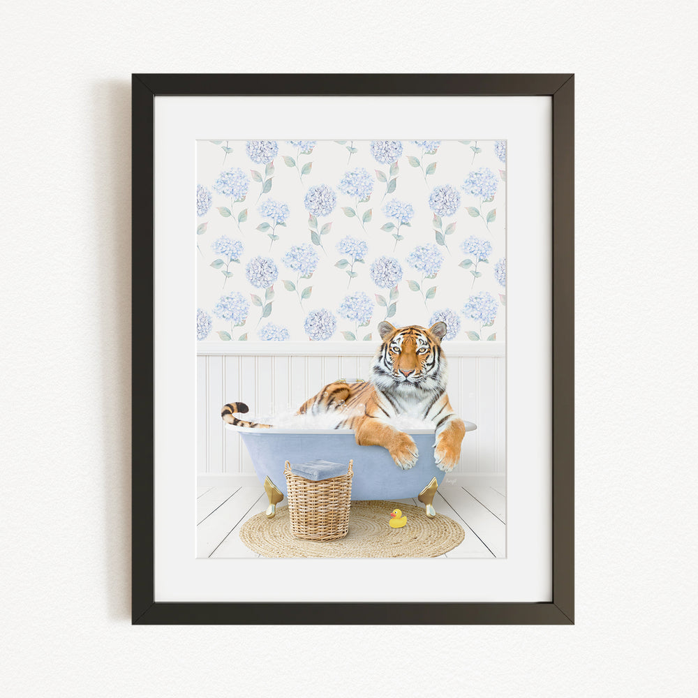 A tiger is sitting in a bathtub filled with water, surrounded by a blue floral pattern on the wall behind it.
