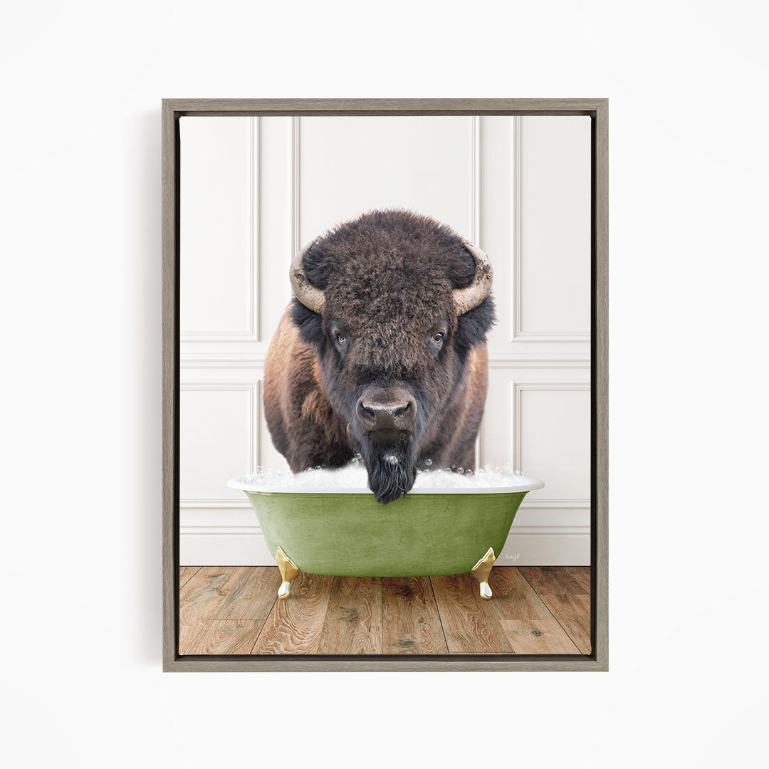 A buffalo with large horns is standing in a green bathtub filled with water, appearing to be enjoying the bath.