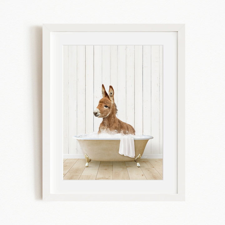 A donkey is sitting in a bathtub filled with water, creating a whimsical and playful scene.