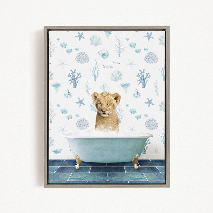 A young lion cub is sitting in a bathtub filled with water, surrounded by a blue and white ocean-themed wallpaper.