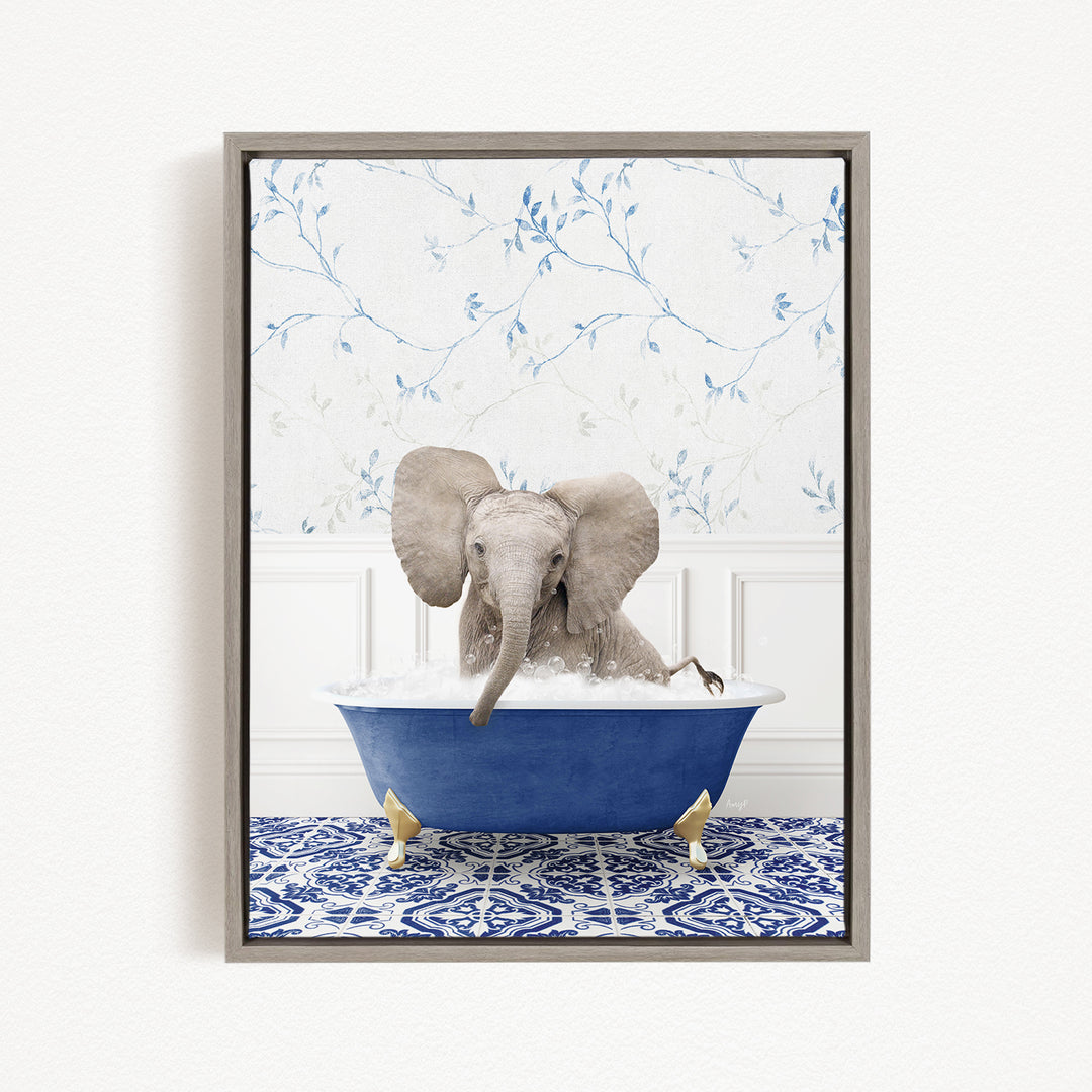 A gray elephant is sitting in a blue bathtub filled with water, surrounded by a blue and white patterned rug.
