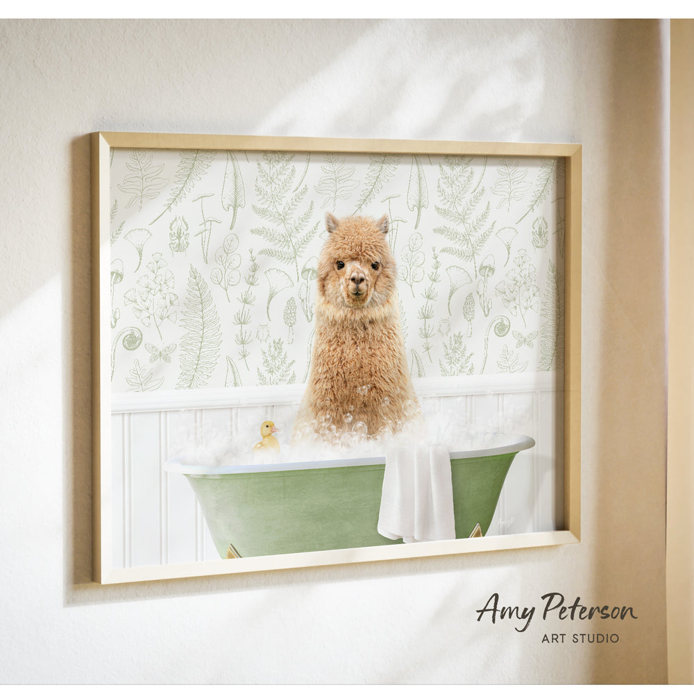 A framed image of a brown alpaca sitting in a green bathtub, surrounded by a white floral pattern.