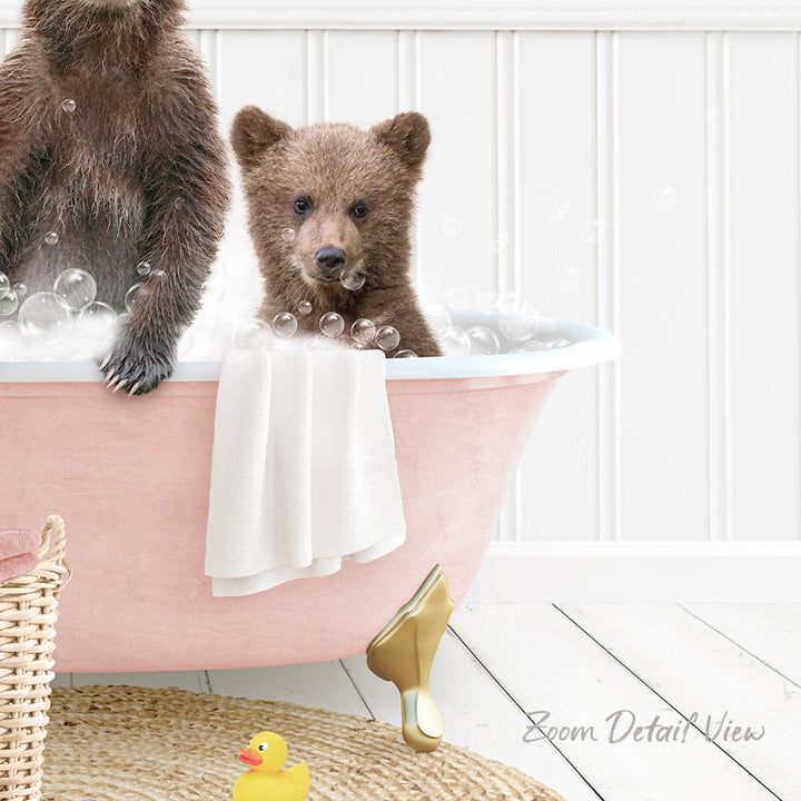 A baby bear sitting in a pink bathtub, surrounded by bubbles, with a yellow rubber duck nearby.