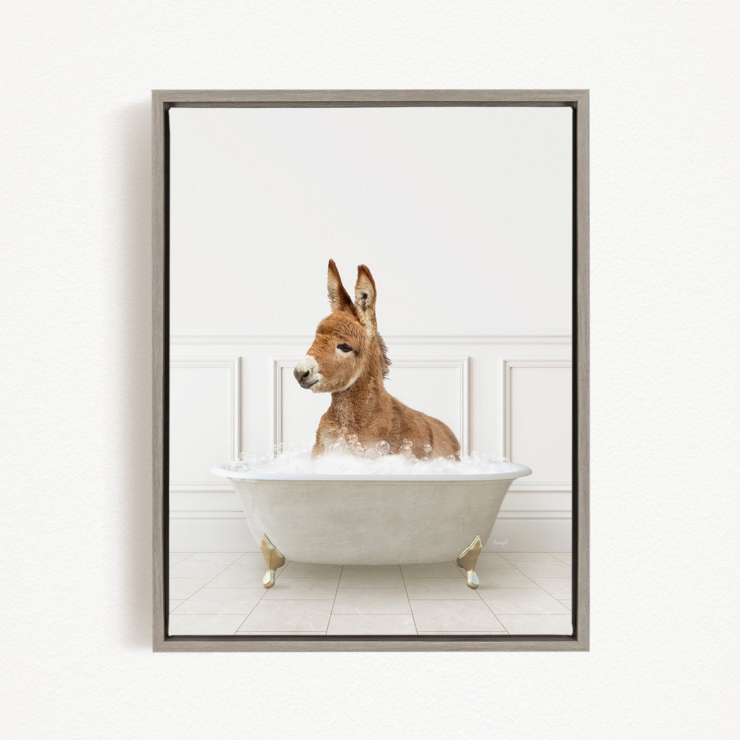 A donkey is sitting in a white bathtub filled with bubbles, looking directly at the camera.