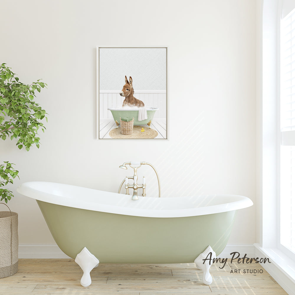 A green clawfoot bathtub with a small dog sitting in it, as depicted in a framed print hanging on the wall above it.