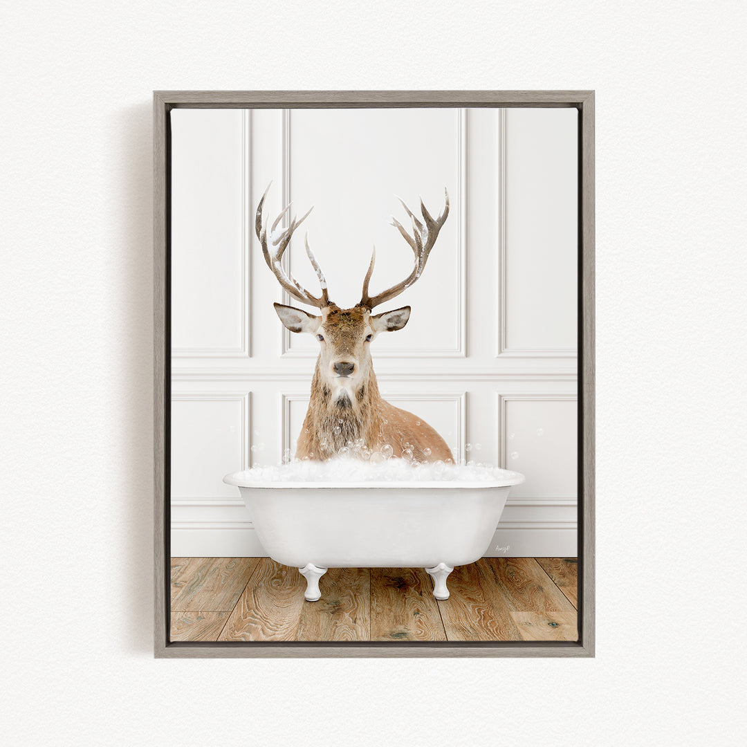 A deer with large antlers is sitting in a white bathtub filled with water, creating a whimsical and unexpected scene.