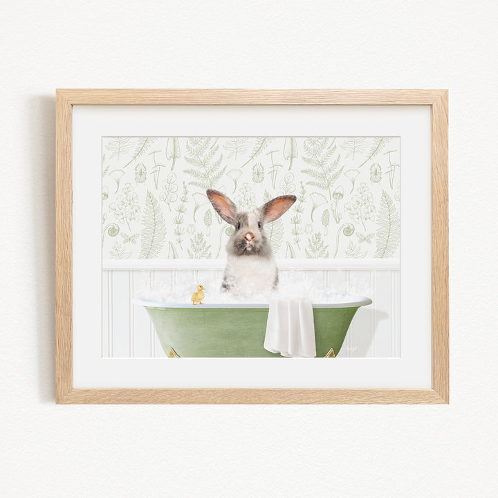 A cute rabbit sitting in a green bathtub filled with bubbles, surrounded by a patterned wallpaper.