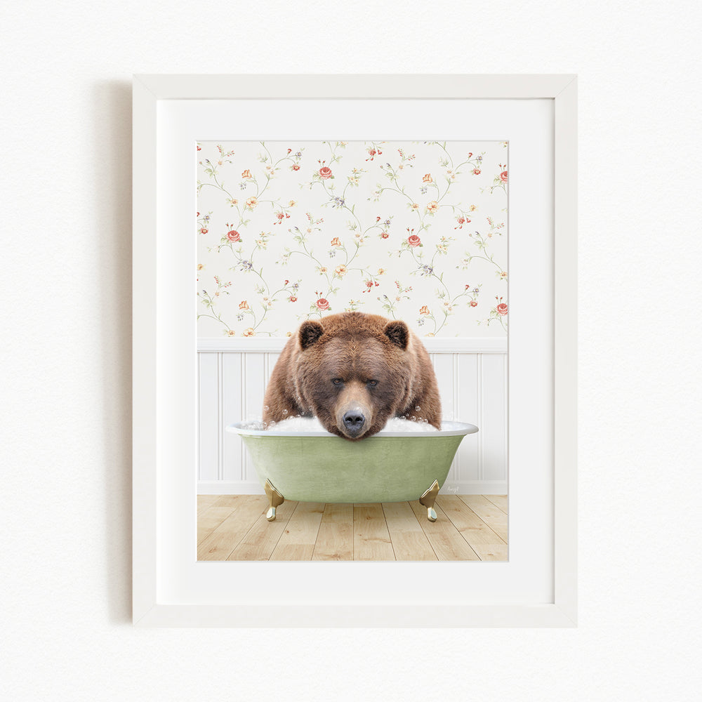 A brown bear is sitting in a green bathtub, with a floral wallpaper in the background.