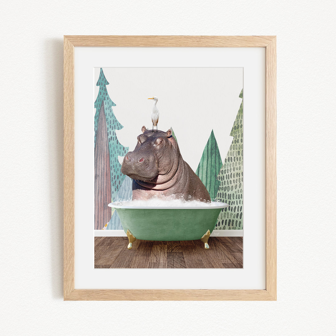 A framed image depicting a hippopotamus sitting in a green bathtub, with a seagull perched on its head.