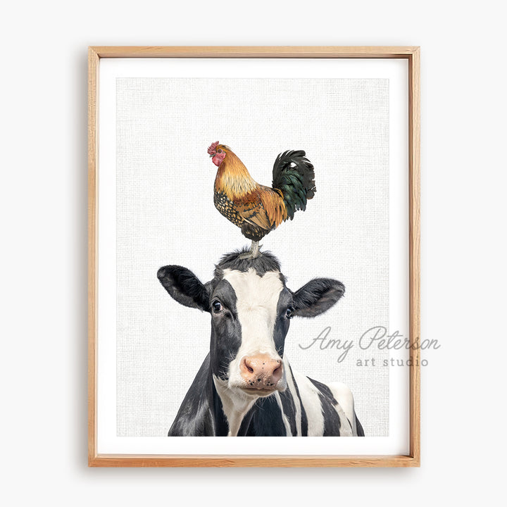 a black and white cow with a rooster on its head