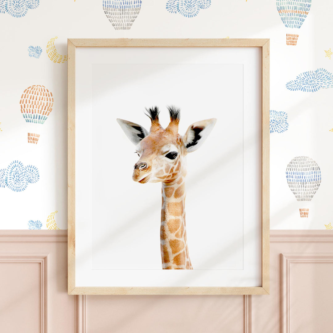 a picture of a giraffe in a frame on a wall