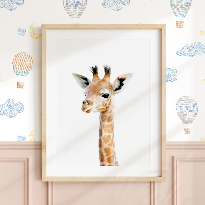 a picture of a giraffe in a frame on a wall