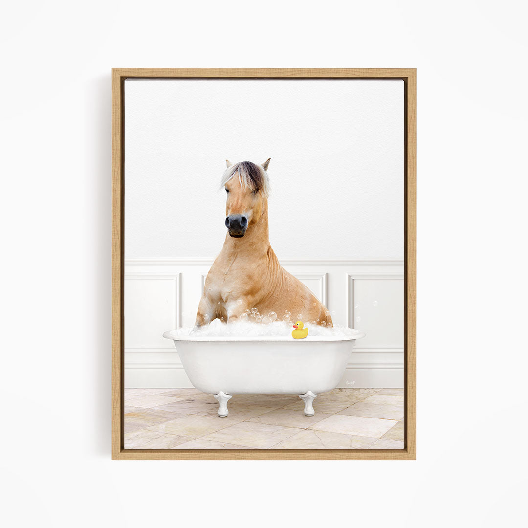 A brown horse is sitting in a white bathtub filled with water, with a rubber duck floating in the water.