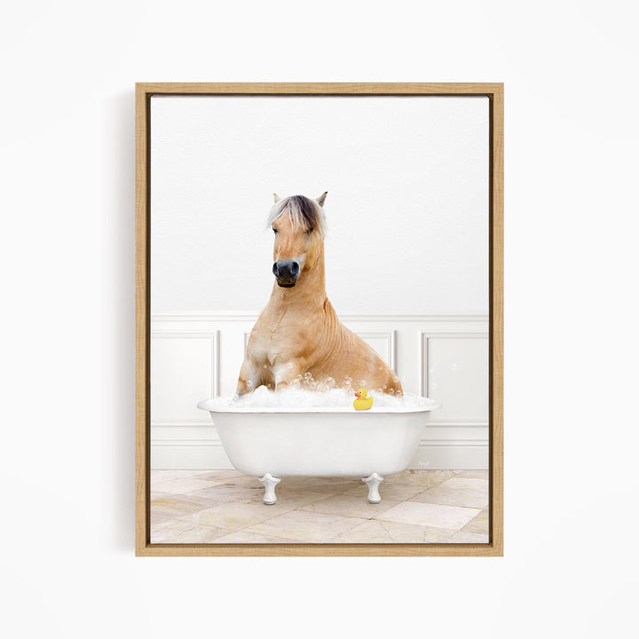 A brown horse is sitting in a white bathtub filled with water, with a rubber duck floating in the water.