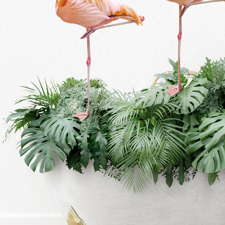 two pink flamingos standing on top of a plant