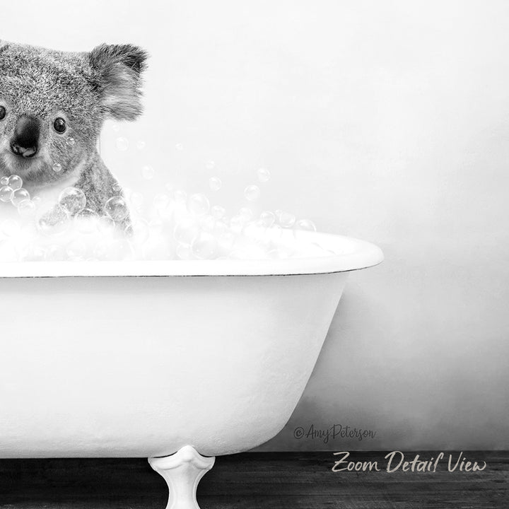 A koala bear sitting in a white bathtub filled with bubbles, creating a whimsical and playful scene.