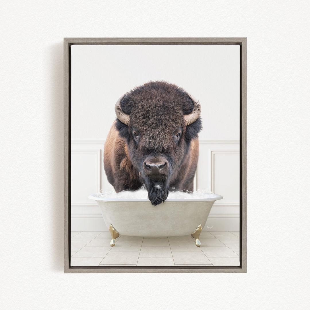 A buffalo with a long beard is sitting in a white bathtub, looking directly at the camera.