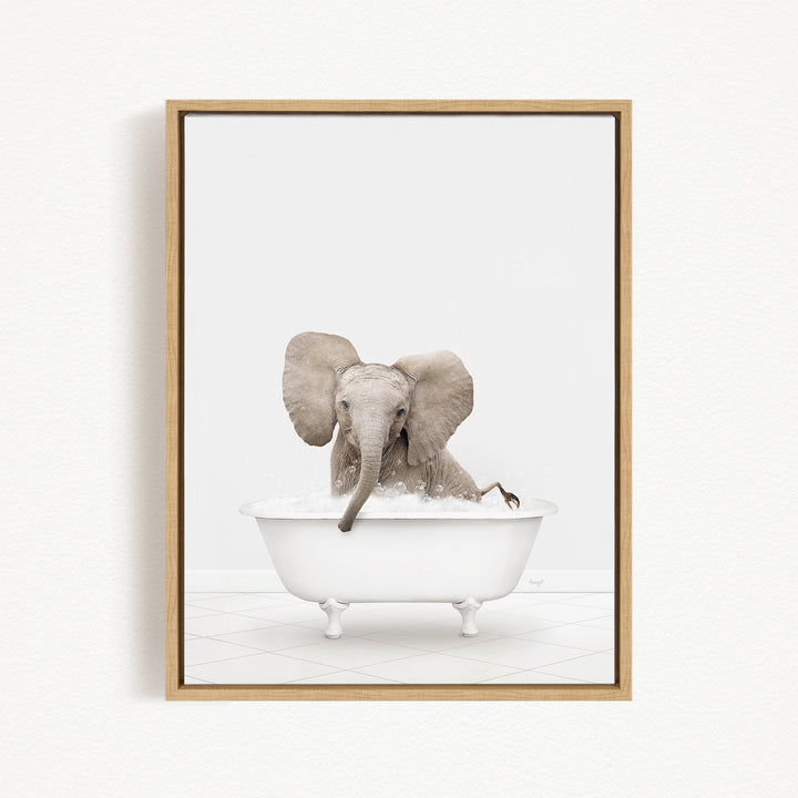 A baby elephant sitting in a white bathtub filled with water, with its trunk submerged in the water.