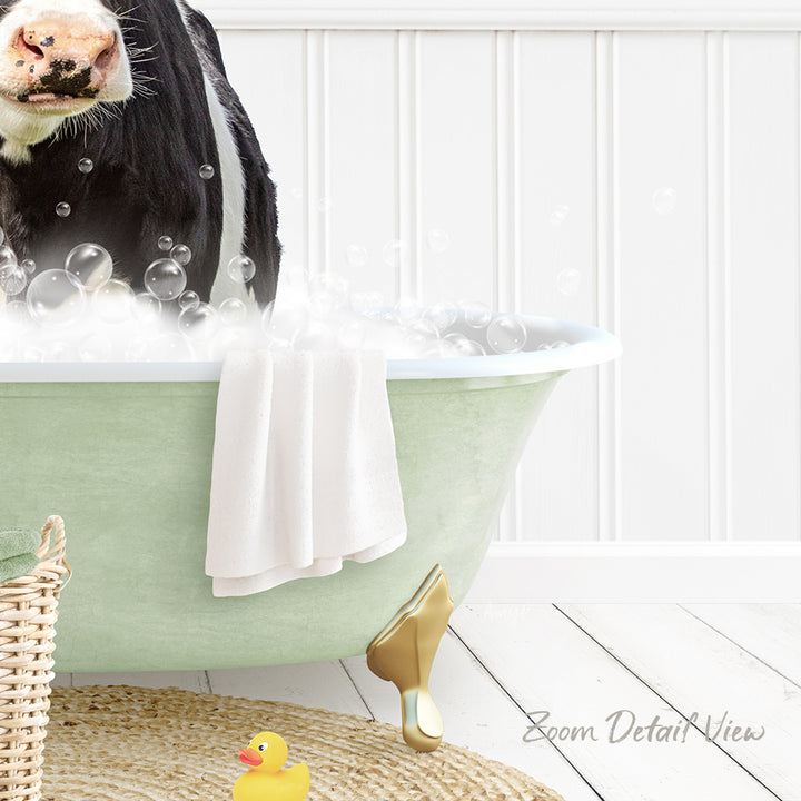 A cow is standing in a green bathtub filled with bubbles, surrounded by a yellow rubber duck and a white towel.