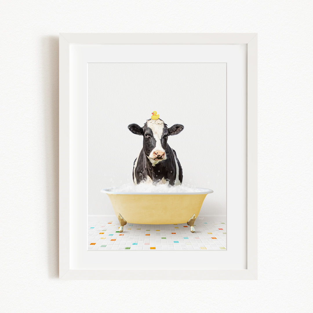 A black and white cow is sitting in a yellow bathtub filled with water, with a yellow rubber duck perched on its head.