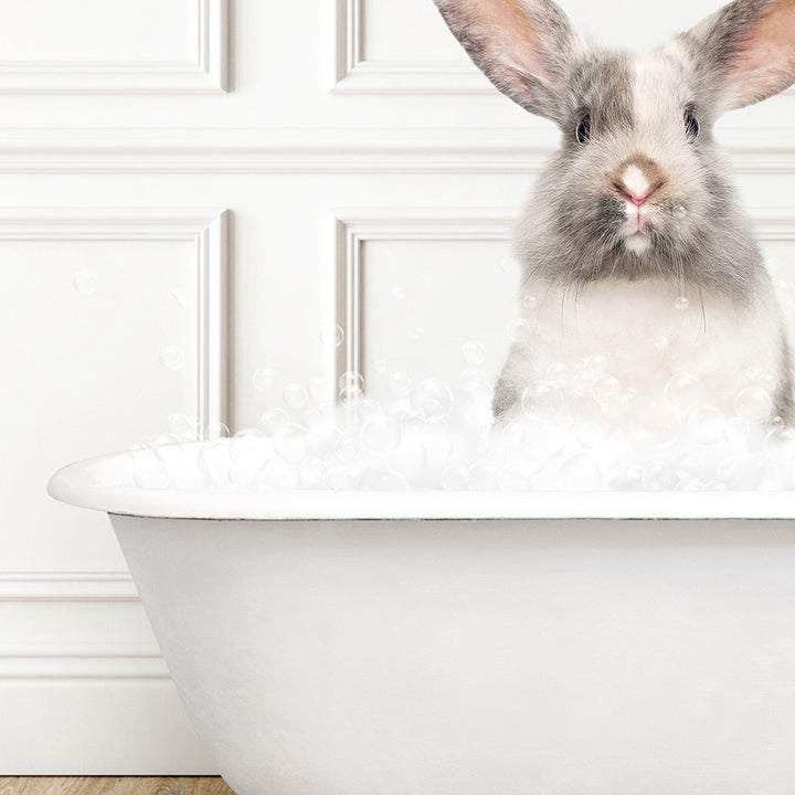 a rabbit is sitting in a bathtub full of bubbles