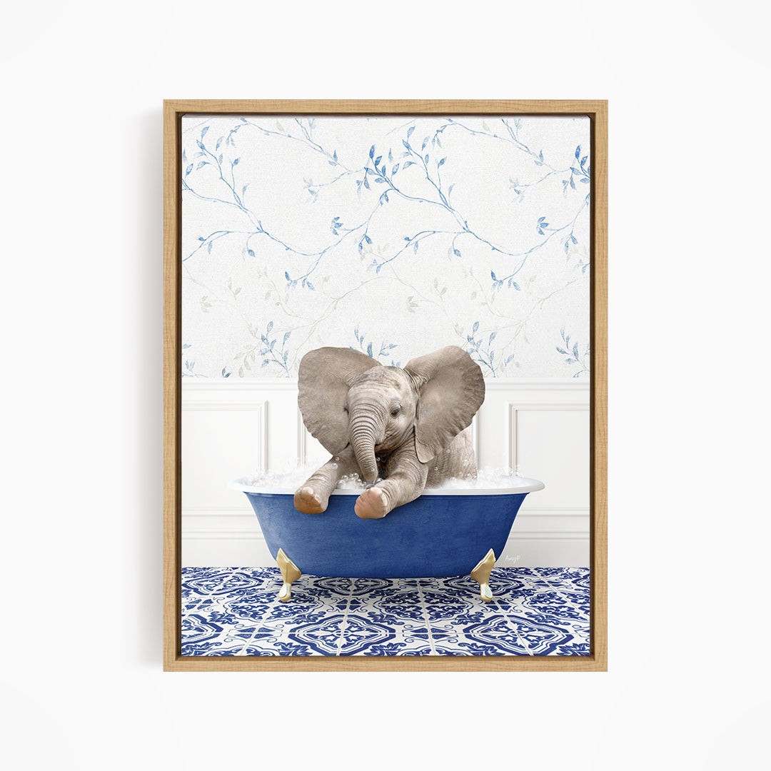 A baby elephant sitting in a blue bathtub, surrounded by a blue and white patterned floor and a floral wallpaper background.