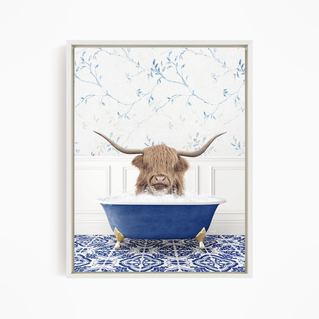 A brown cow with long horns is sitting in a blue bathtub filled with water, surrounded by a blue and white patterned floor.
