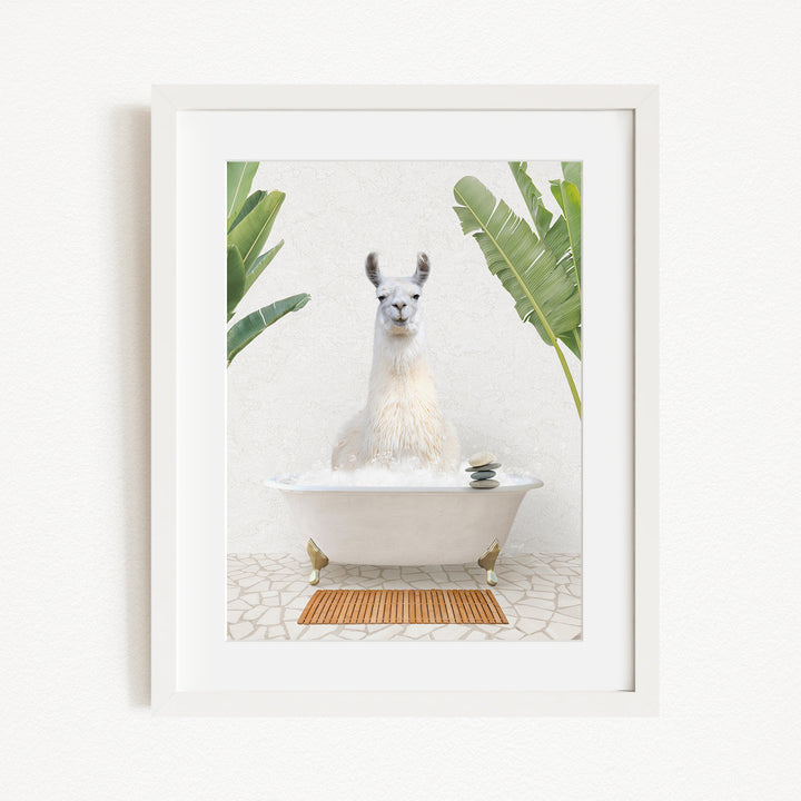 A white llama sitting in a white bathtub, surrounded by green plants, in a framed artwork.