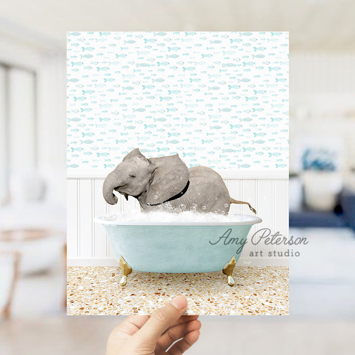 a hand holding up a card with an elephant in a bathtub