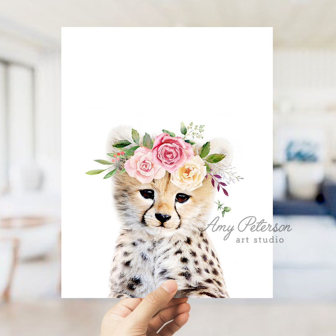 a hand holding a card with a picture of a cheetah wearing a flower