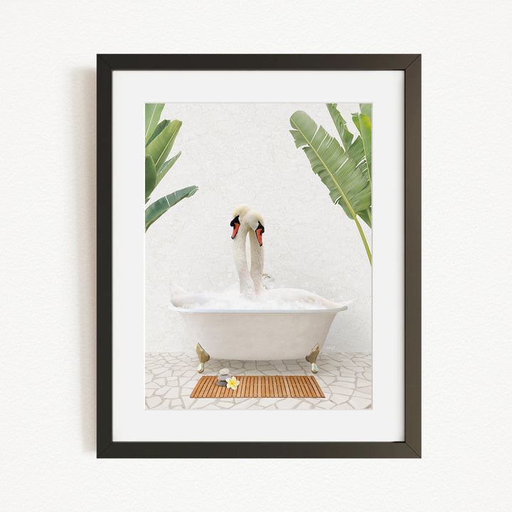 A white swan sitting in a white bathtub, surrounded by green plants, in a framed artwork.