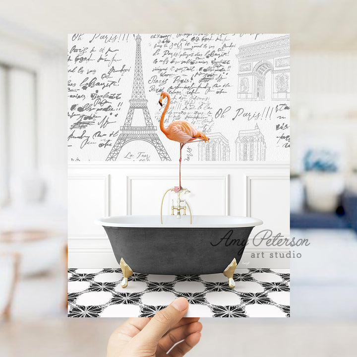 a person holding up a card with a flamingo in a bathtub